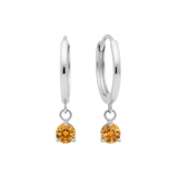 Qutahia Jewelry 14k solid gold dangling huggie earrings with orange citrine gemstones in a claw setting.