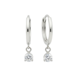 Qutahia Jewelry 14k solid gold dangling huggie earrings with clear claw-set solitaire gemstone.
